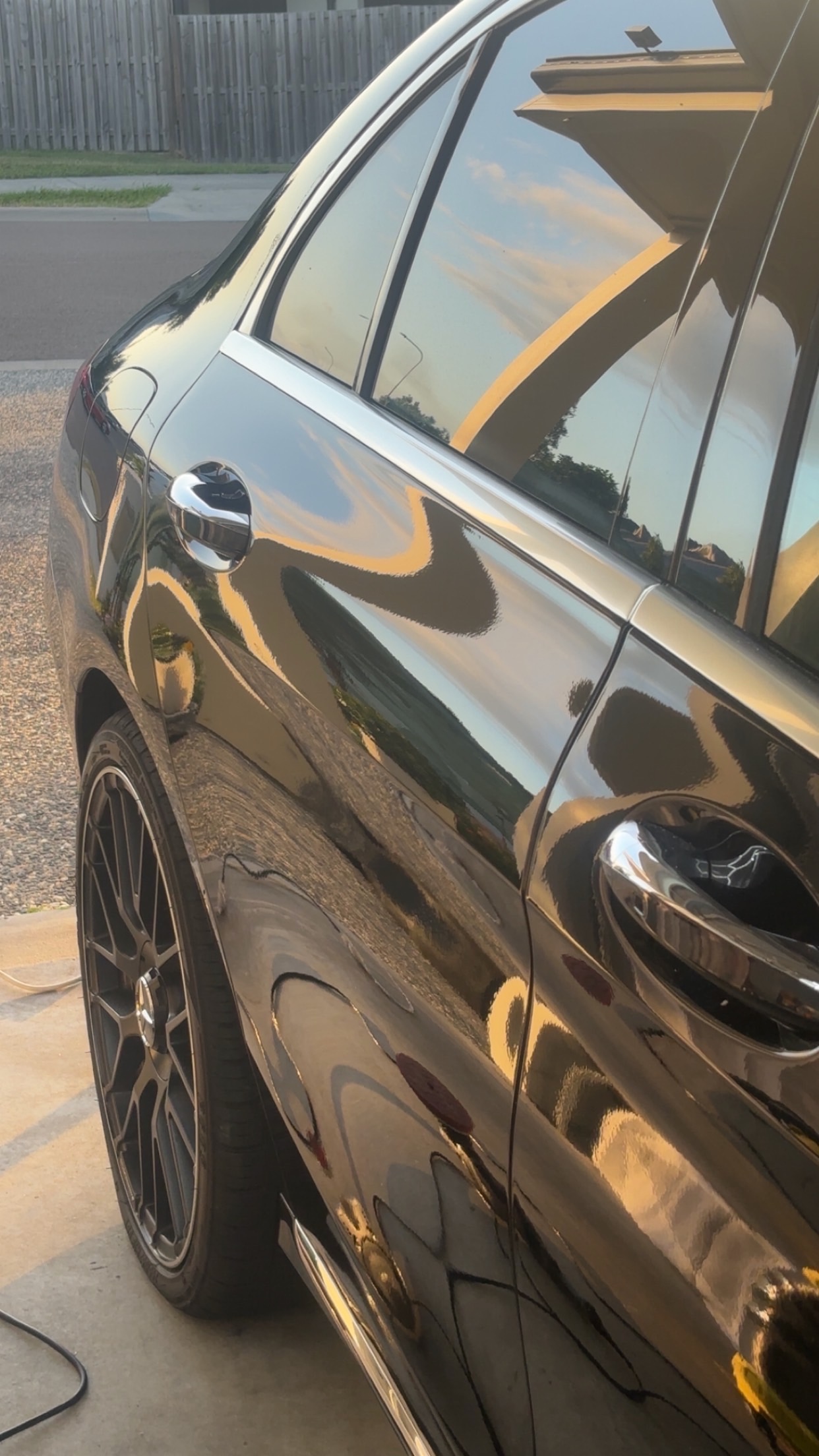 Glossy black paint finish showing strong reflections after protective detailing.