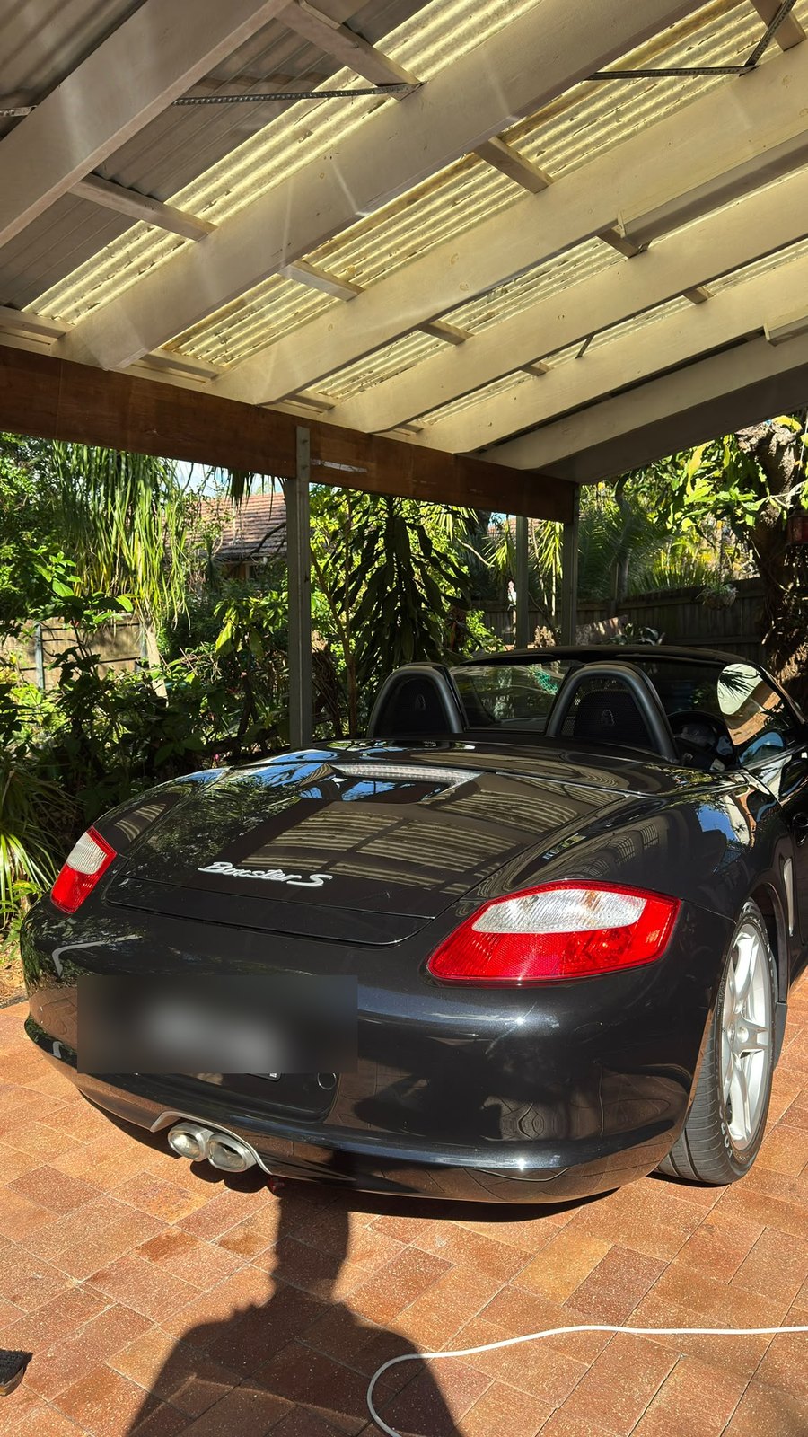 Black Porsche rear three-quarter view showing a deep, glossy ceramic finish